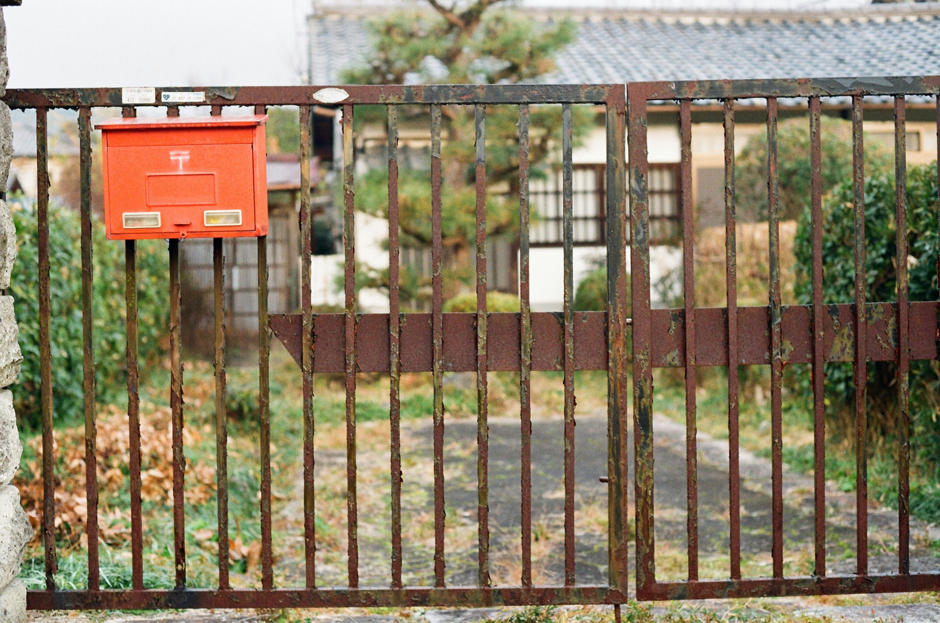 Bright red Japanese street mailbox with postal mark