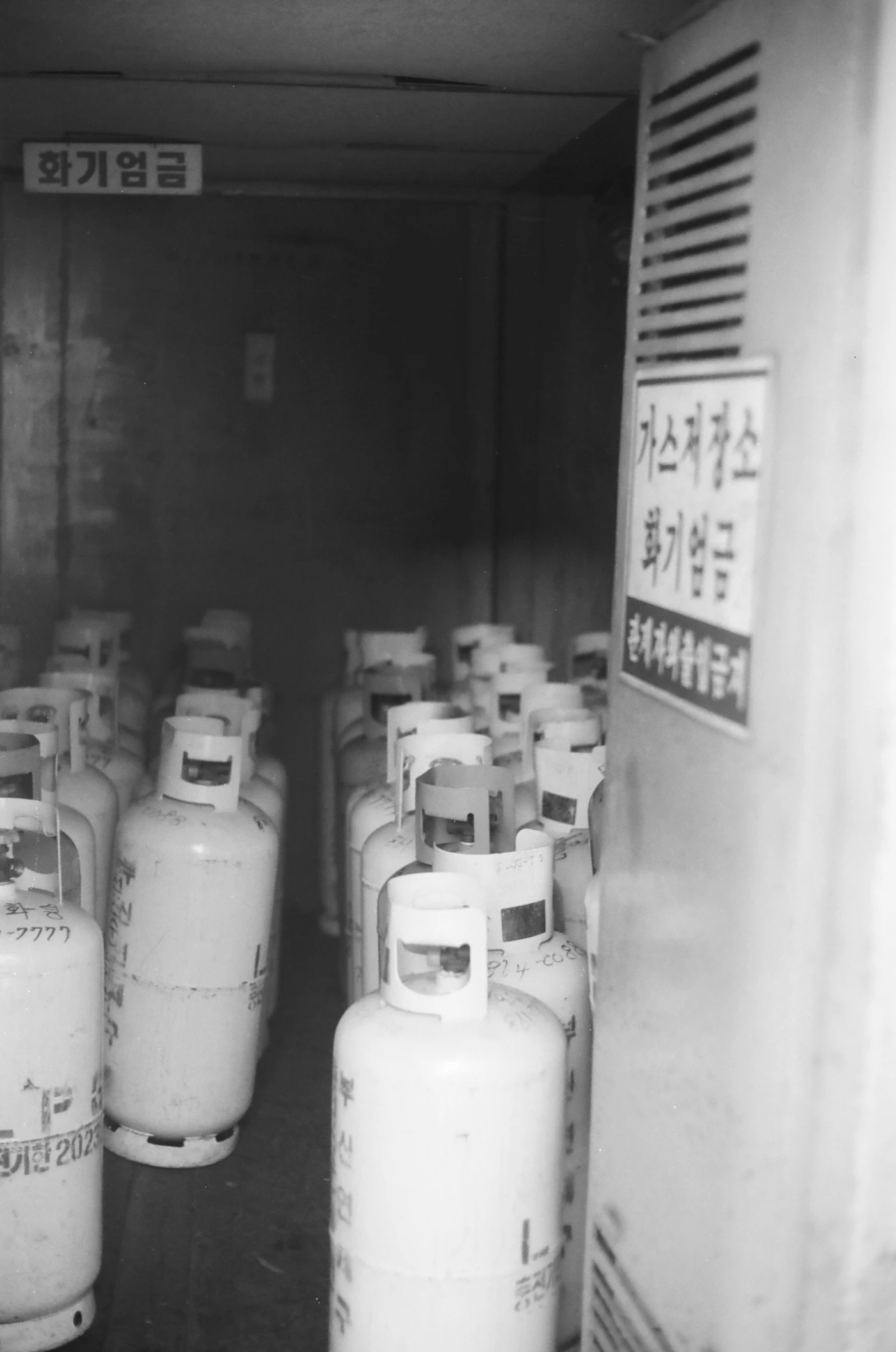 Rows of LPG cylinders representing regulated gas supply