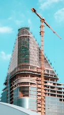 A tall building under construction with a crane.