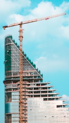 Construction crane next to a modern building under development.