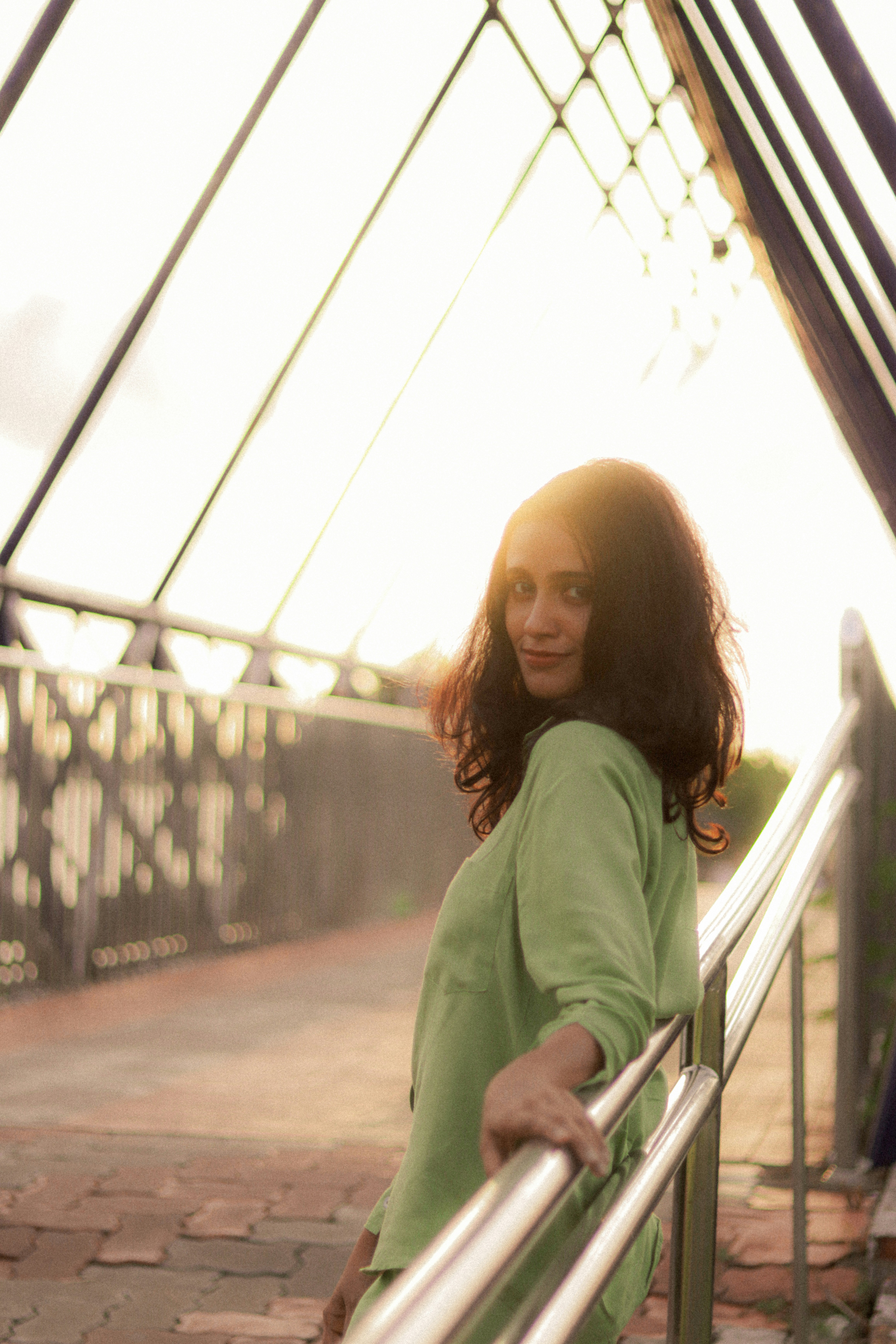 Woman in a green shirt on a bridge