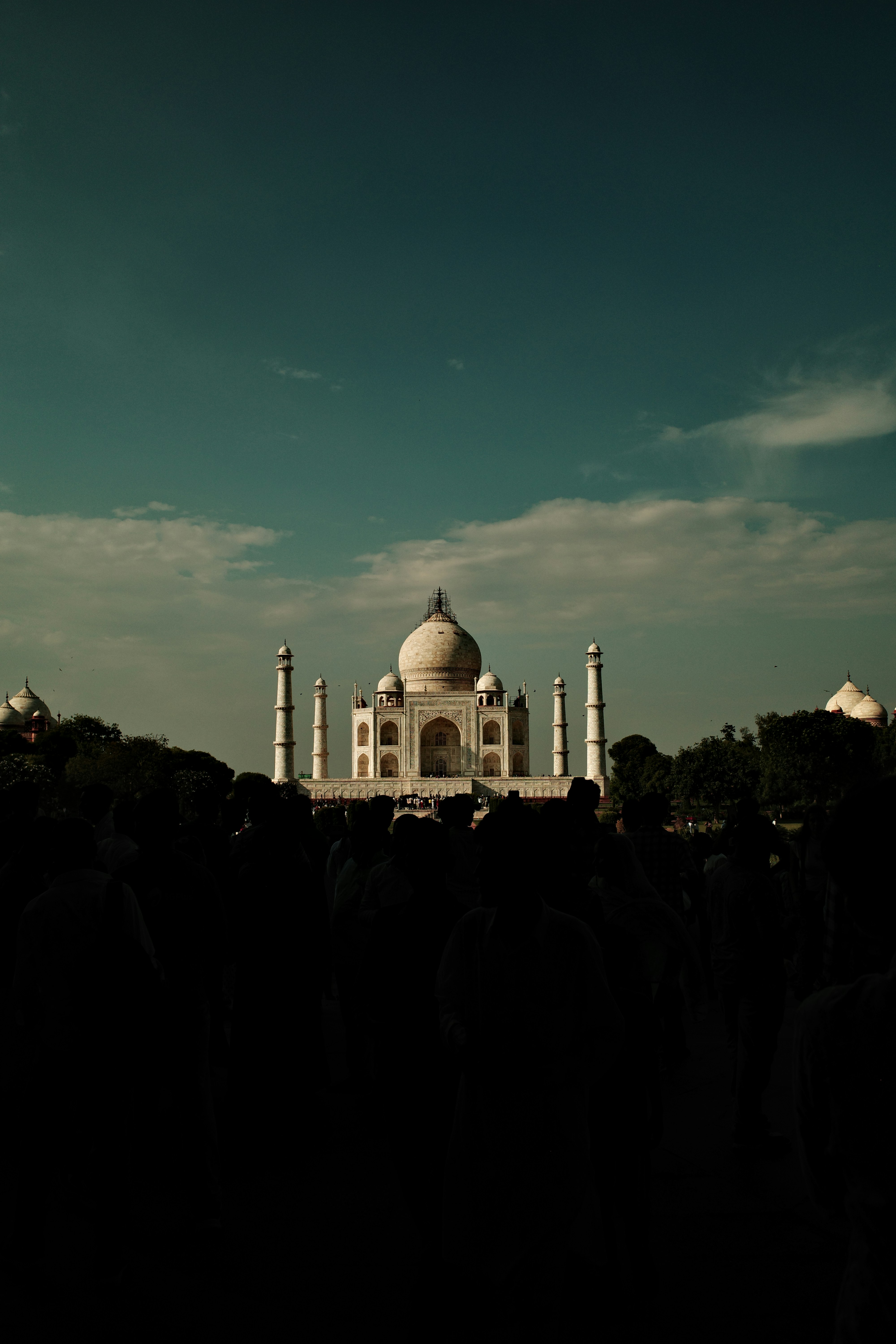 The taj mahal stands majestically against a blue sky.