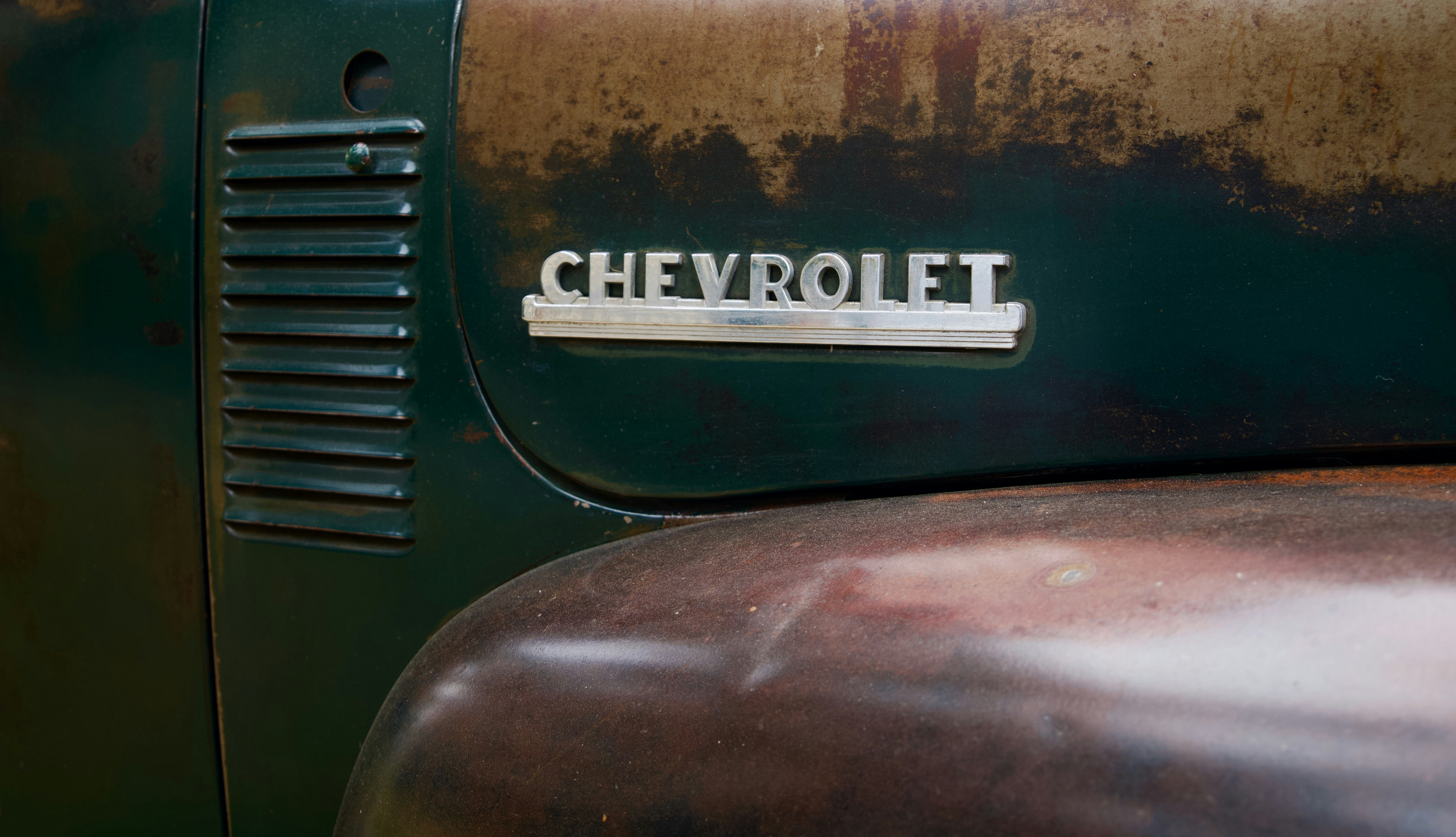 Close-up of a vintage chevrolet truck emblem.