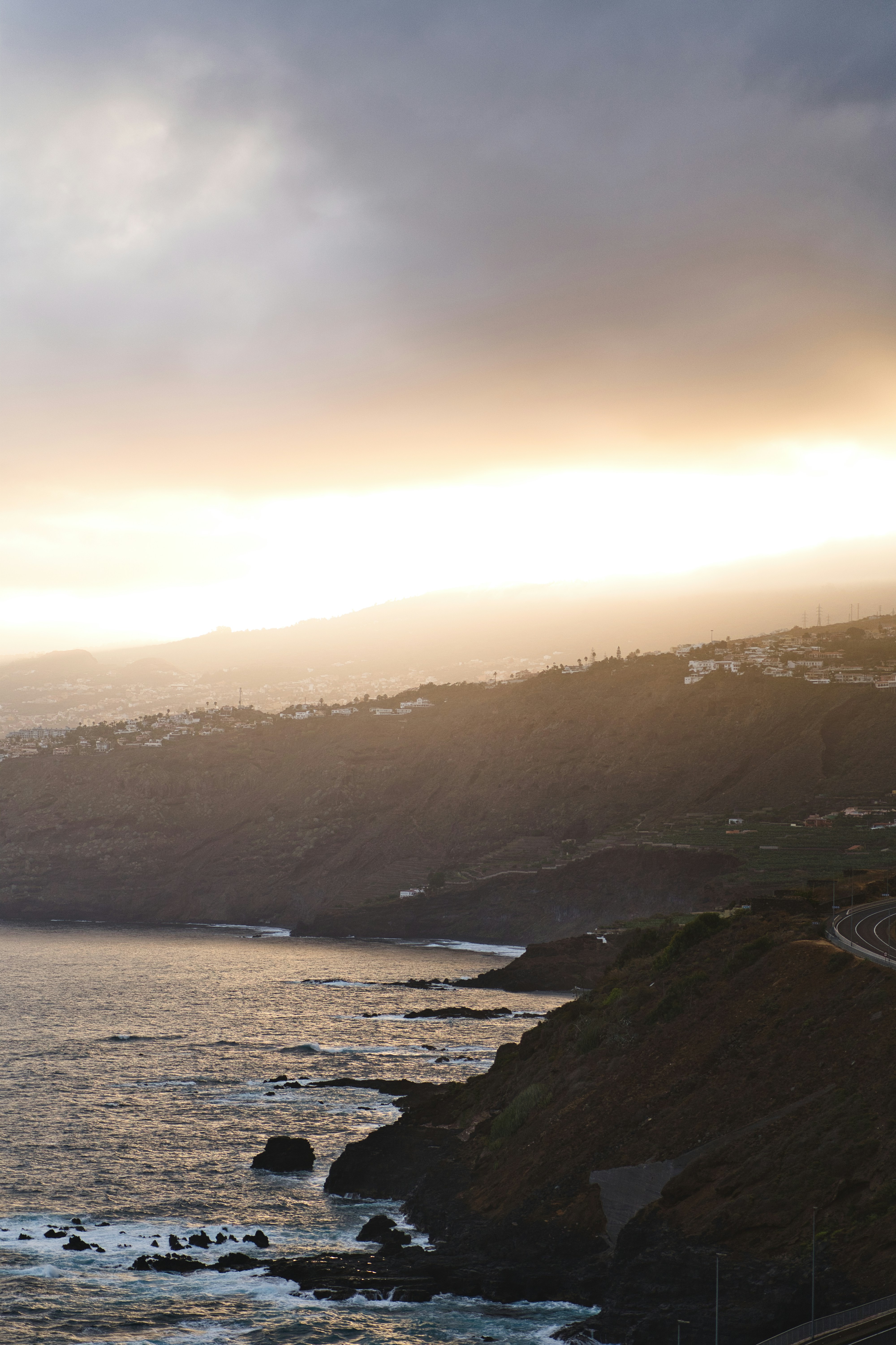Coastal hills bathed in soft sunset light