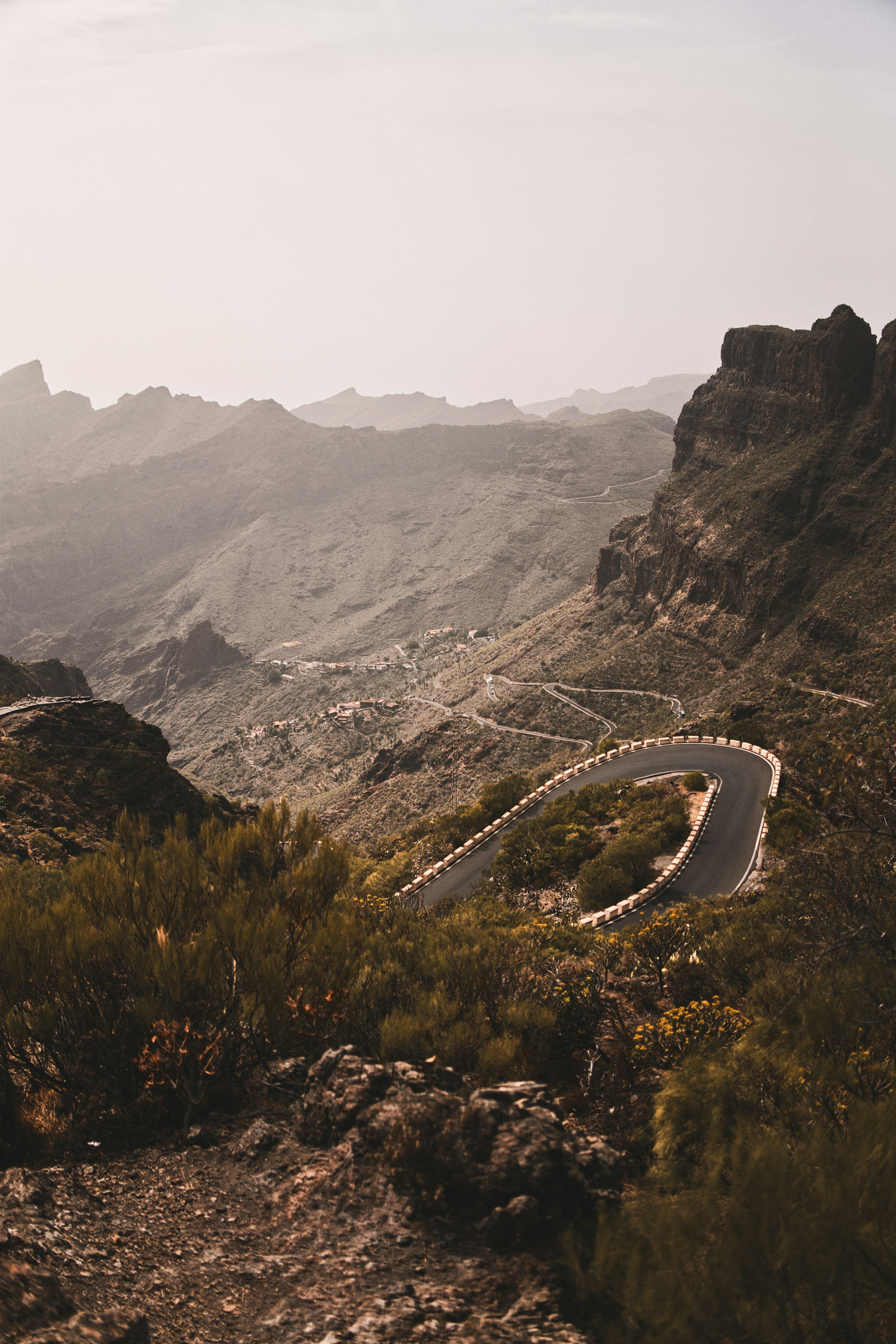 Winding mountain road through a rugged, arid landscape.