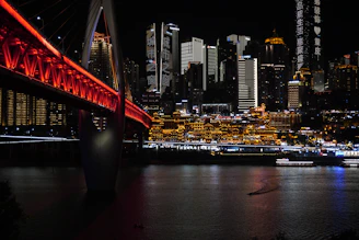 Modern cityscape with illuminated bridge at night
