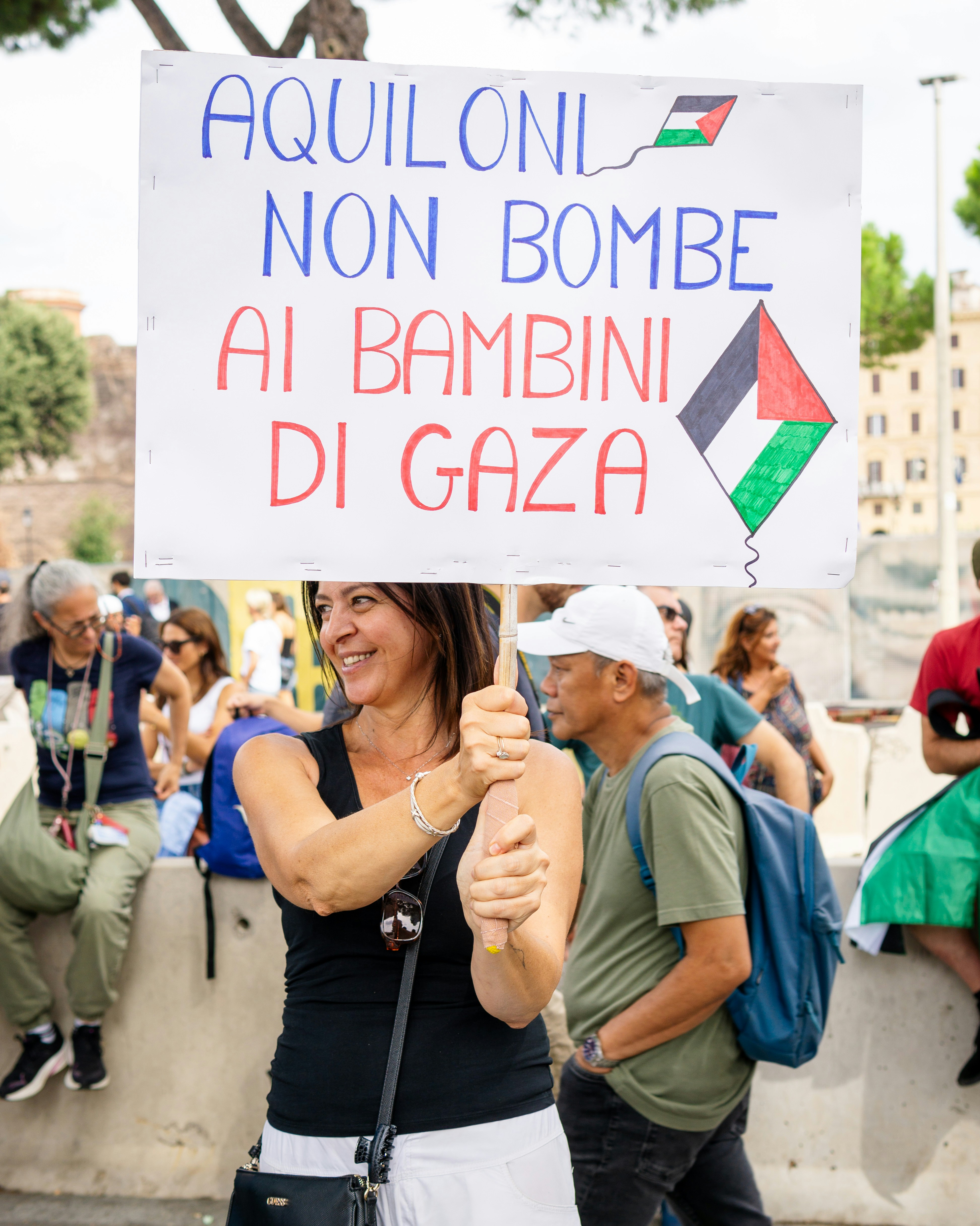 Woman holds protest sign for gaza children.