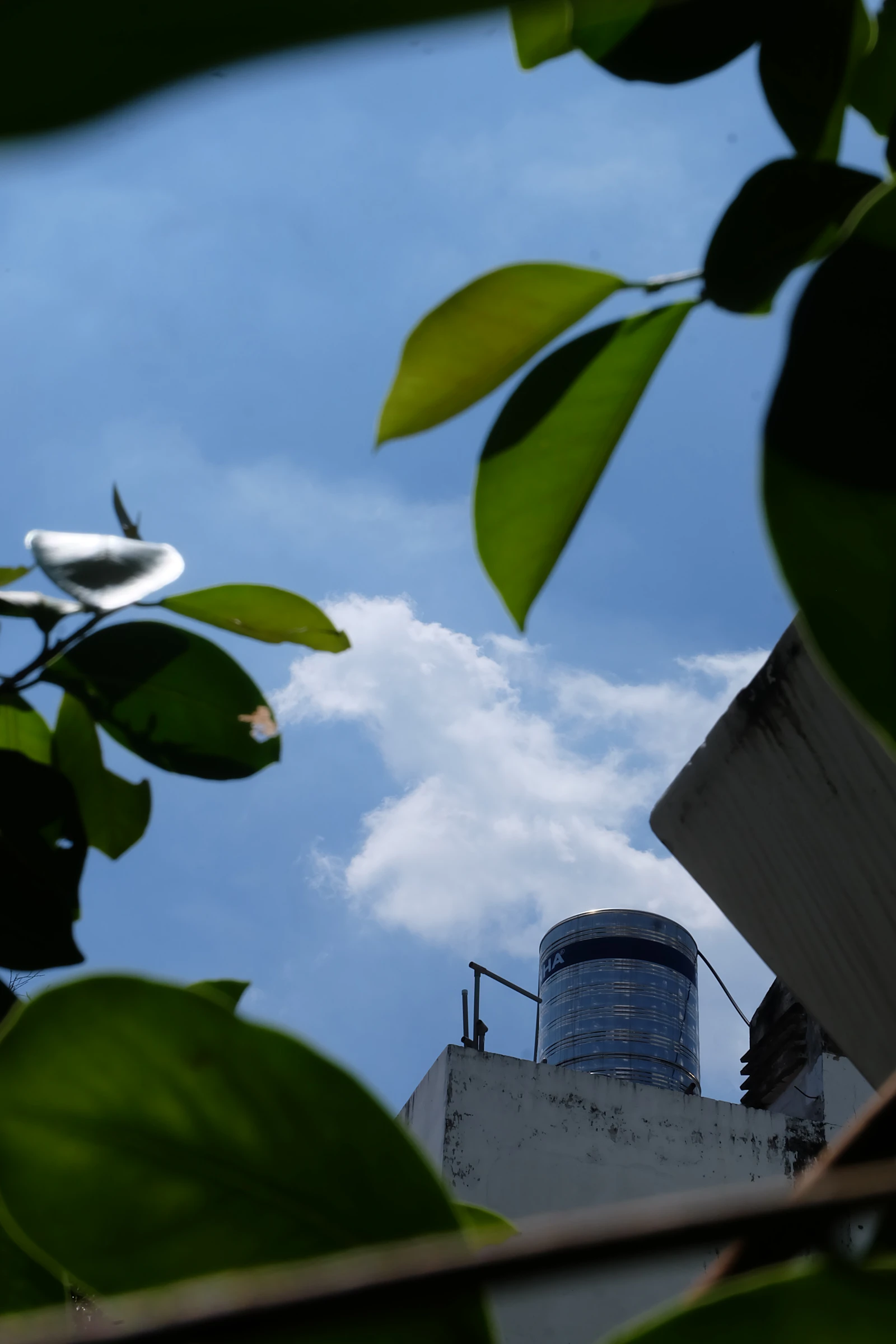Rooftop water tank against a blue sky