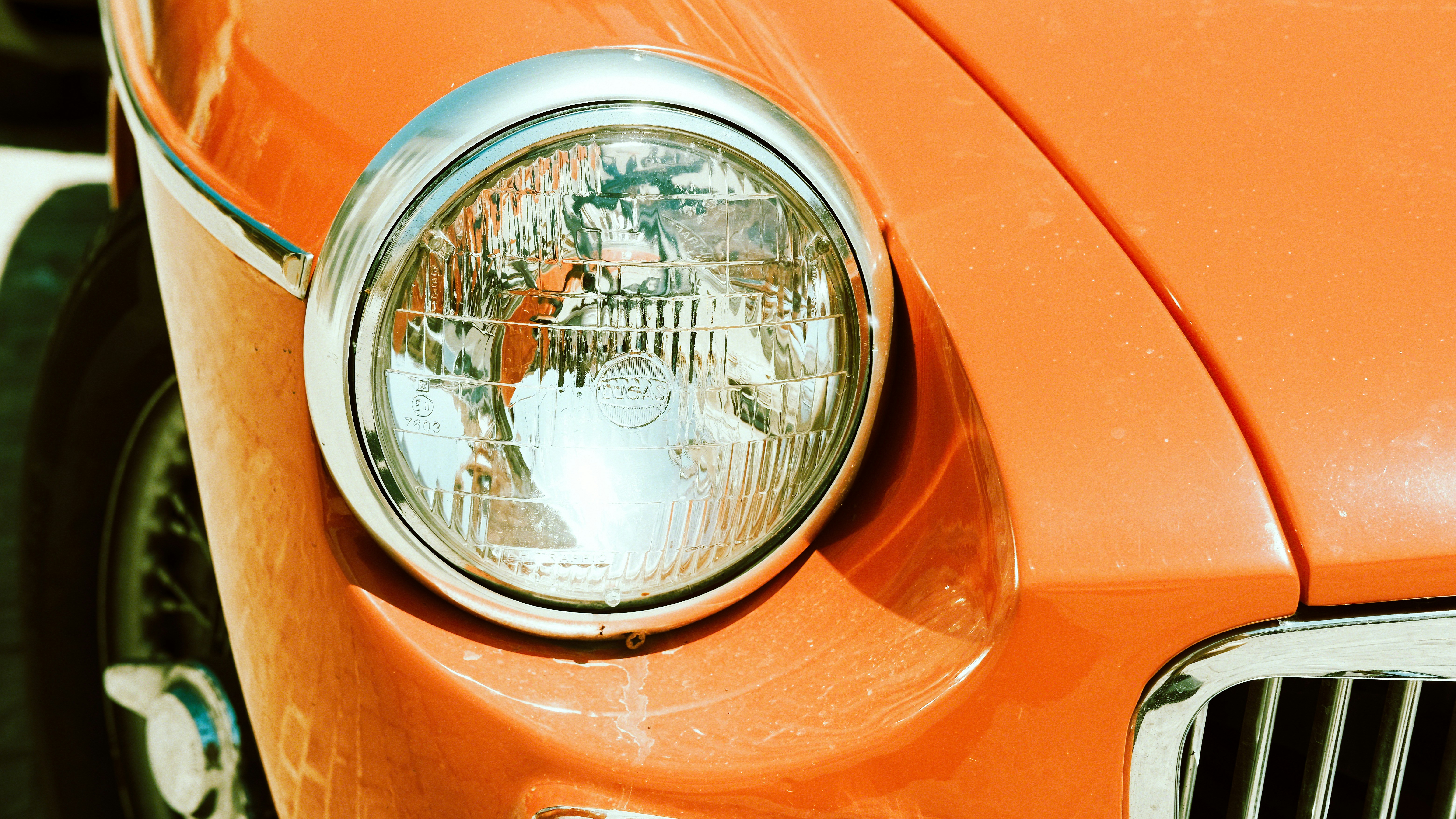 Close-up of a vintage orange car headlight