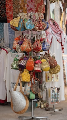 Colorful beaded bags and purses displayed on a rack.
