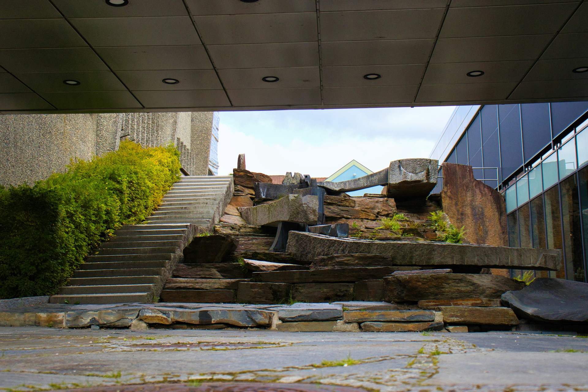Modern architecture with stone waterfall and stairs