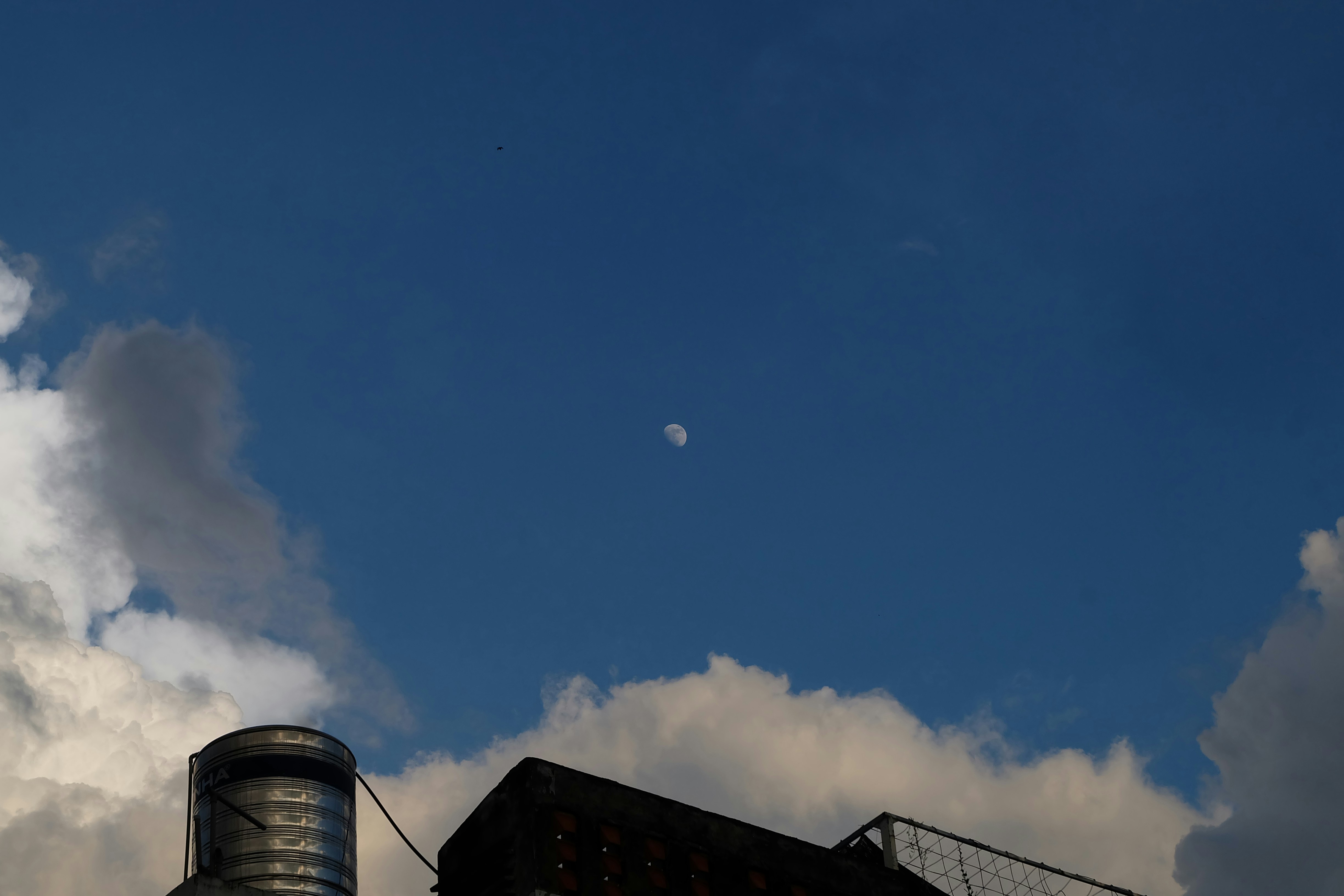 The moon is visible in the daytime sky.