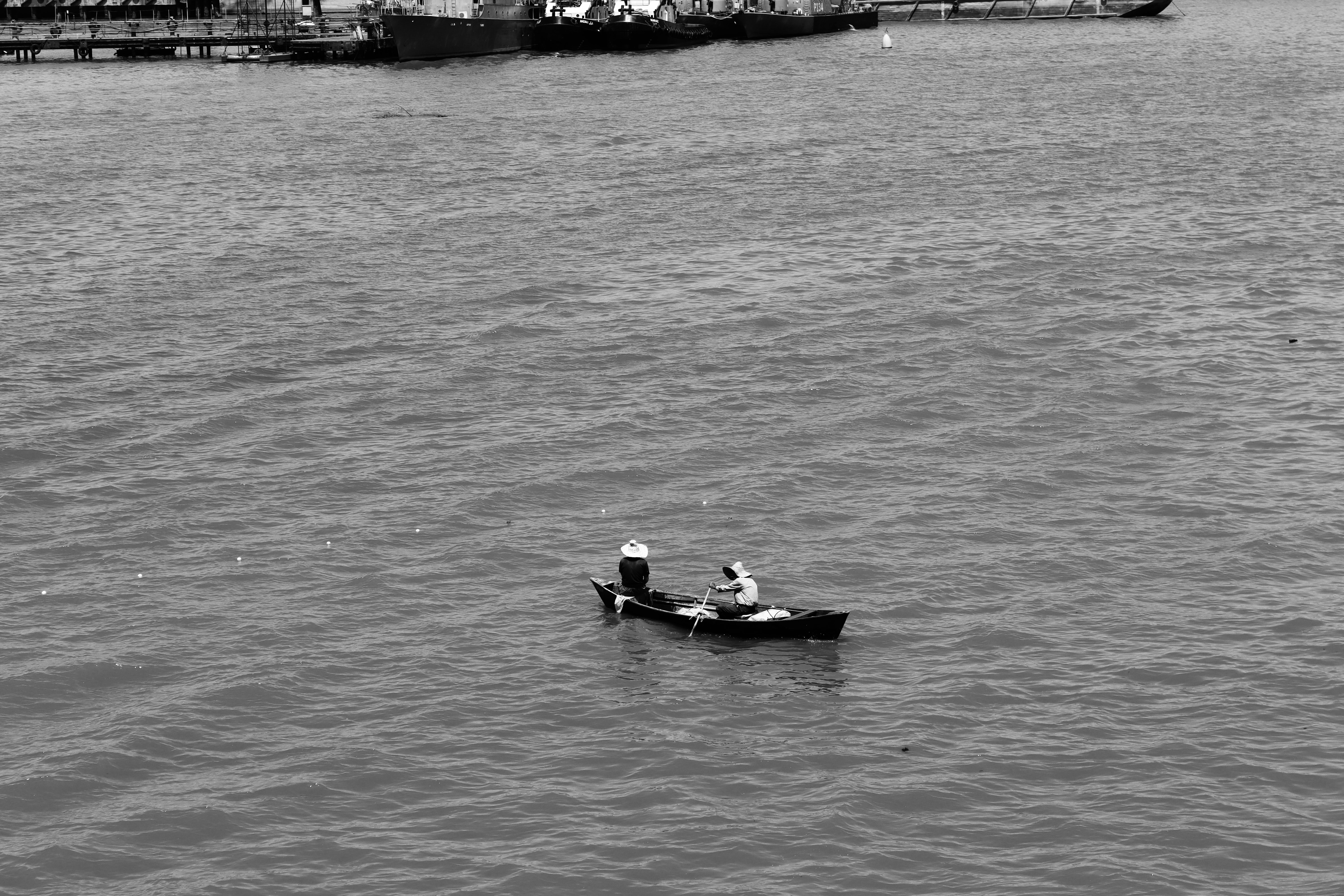 Two people in a small boat on the water