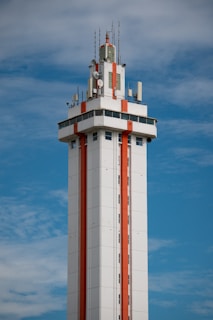 Citruc Tower with orange stripes against blue sky.