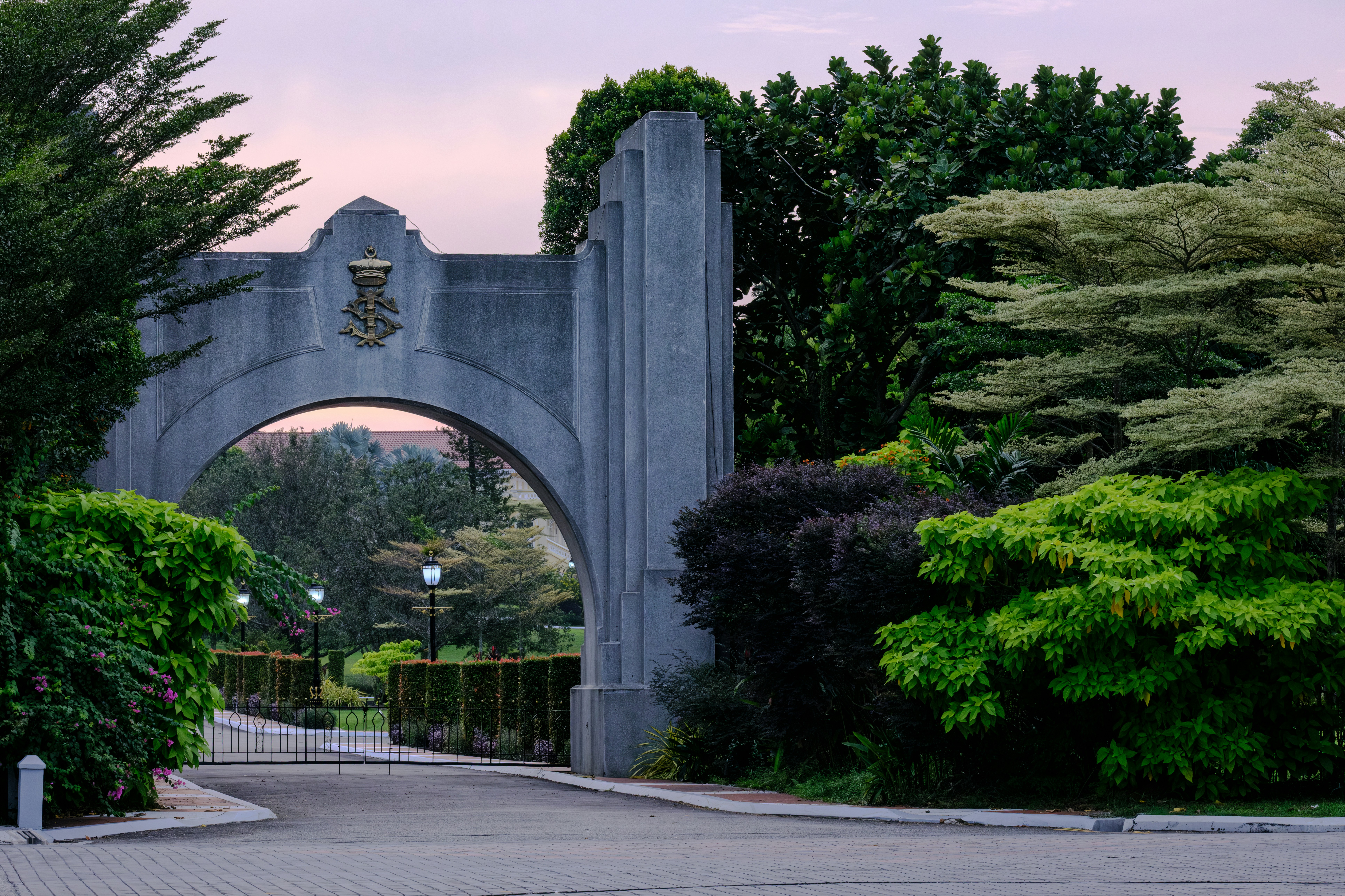 Stone archway entrance to a park with lush greenery