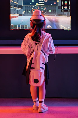 Young child playing video games with headphones on.