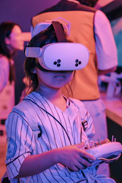 Child wearing vr headset holding a controller.
