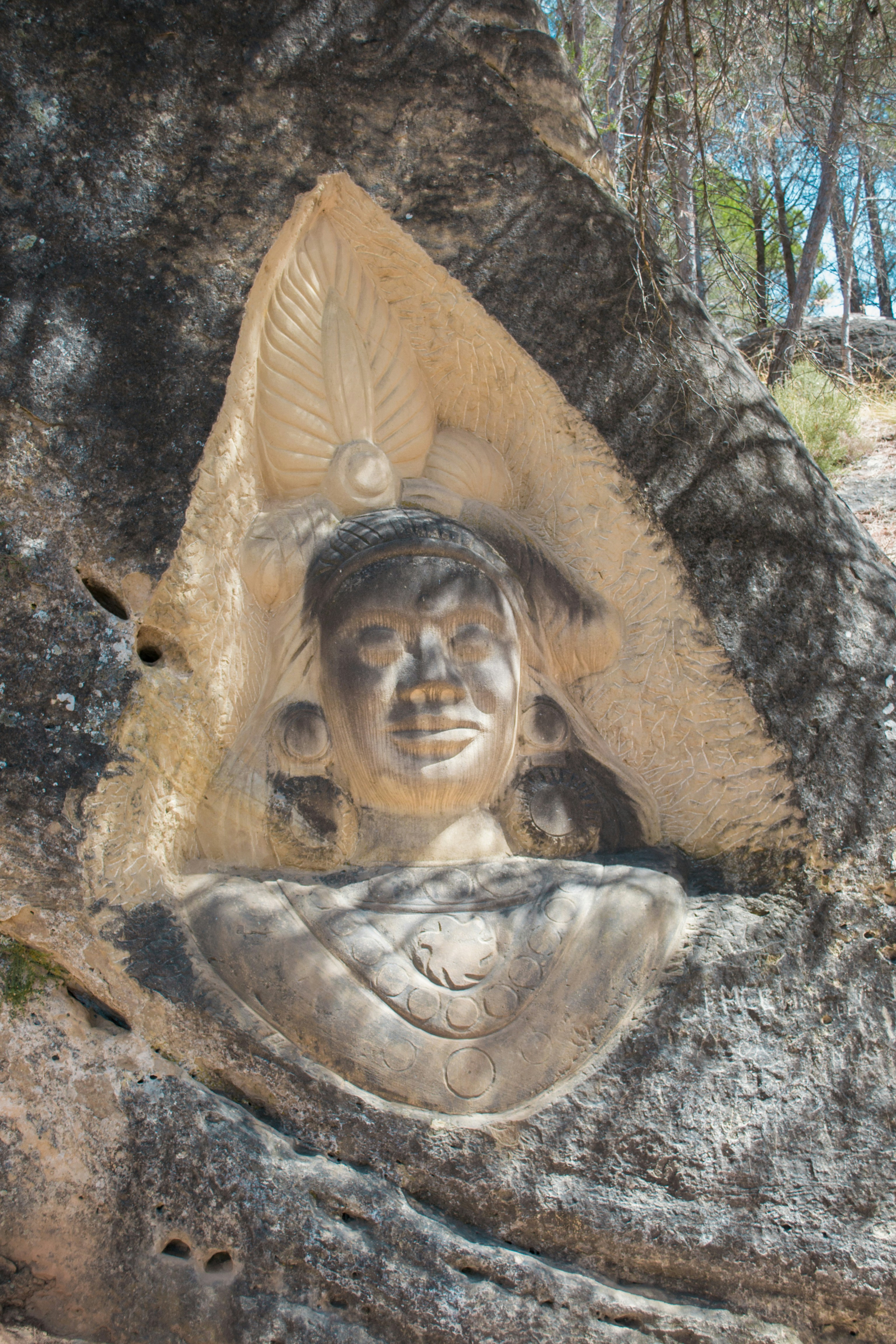 Carving of a face on a rock face.