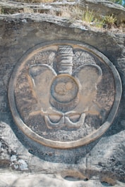 Stone carving of a pelvis with fetus inside