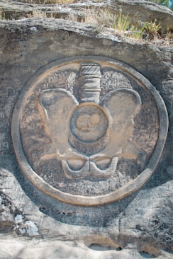 Stone carving of a pelvis with fetus inside
