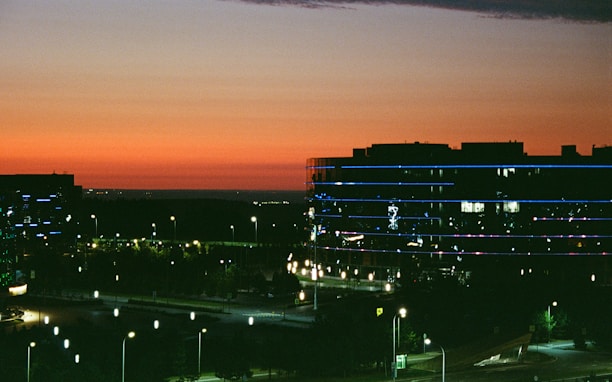 Cityscape with illuminated buildings at dusk.