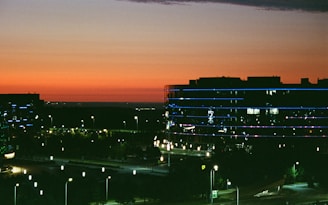 Cityscape with illuminated buildings at dusk.