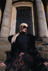Woman in black fur coat and lace dress