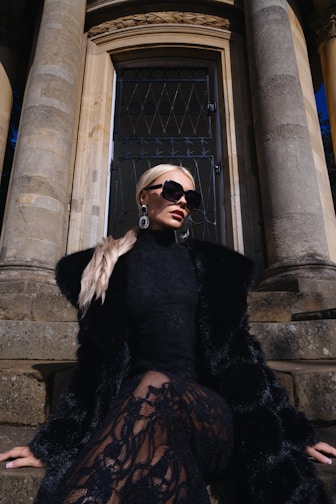 Woman in black fur coat and lace dress