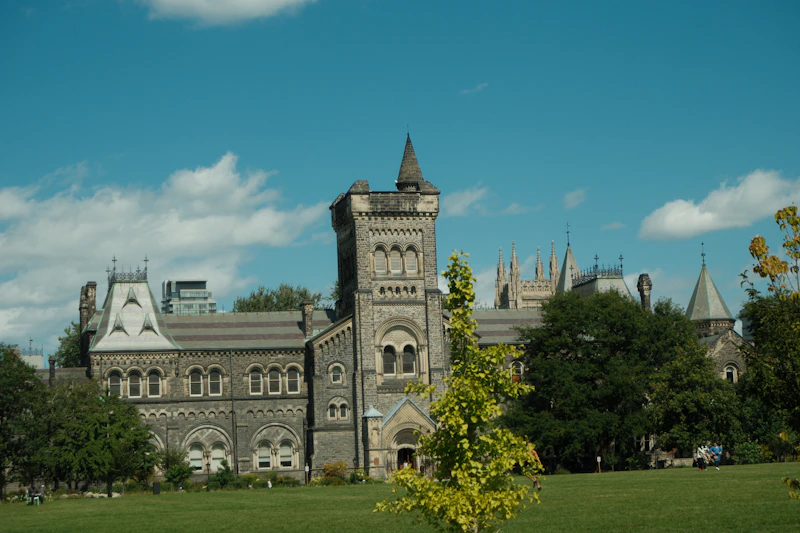 Gothic stone building and lawn at King's College Circle, University of Toronto, Canada
