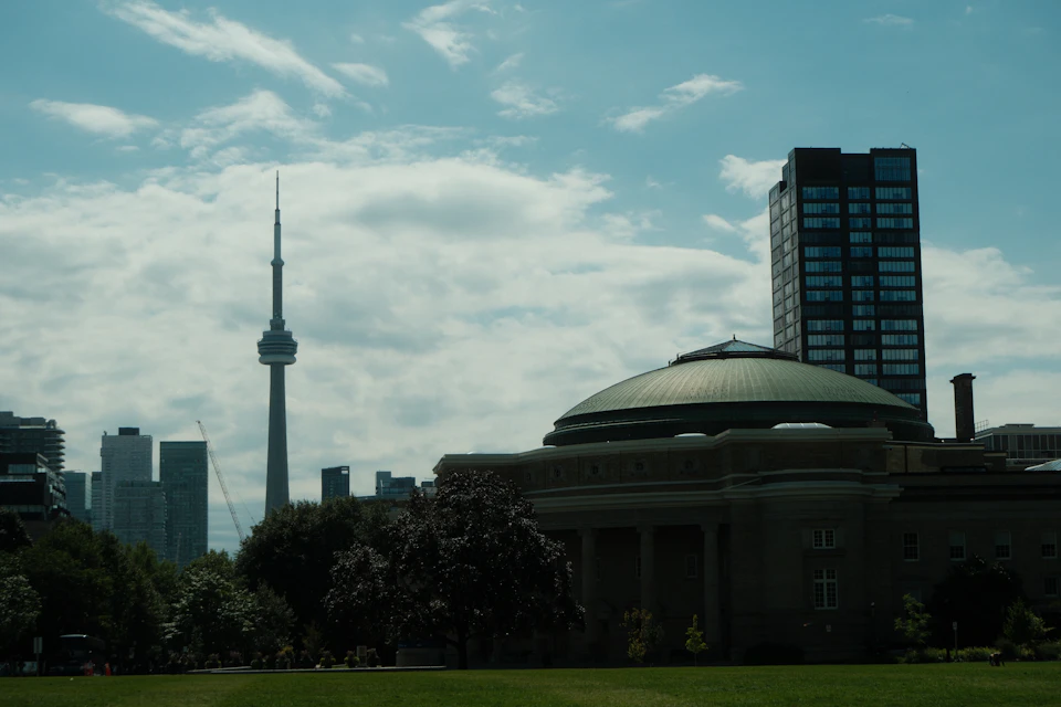 Gray tower stands out against a clear blue sky with surrounding urban landscape