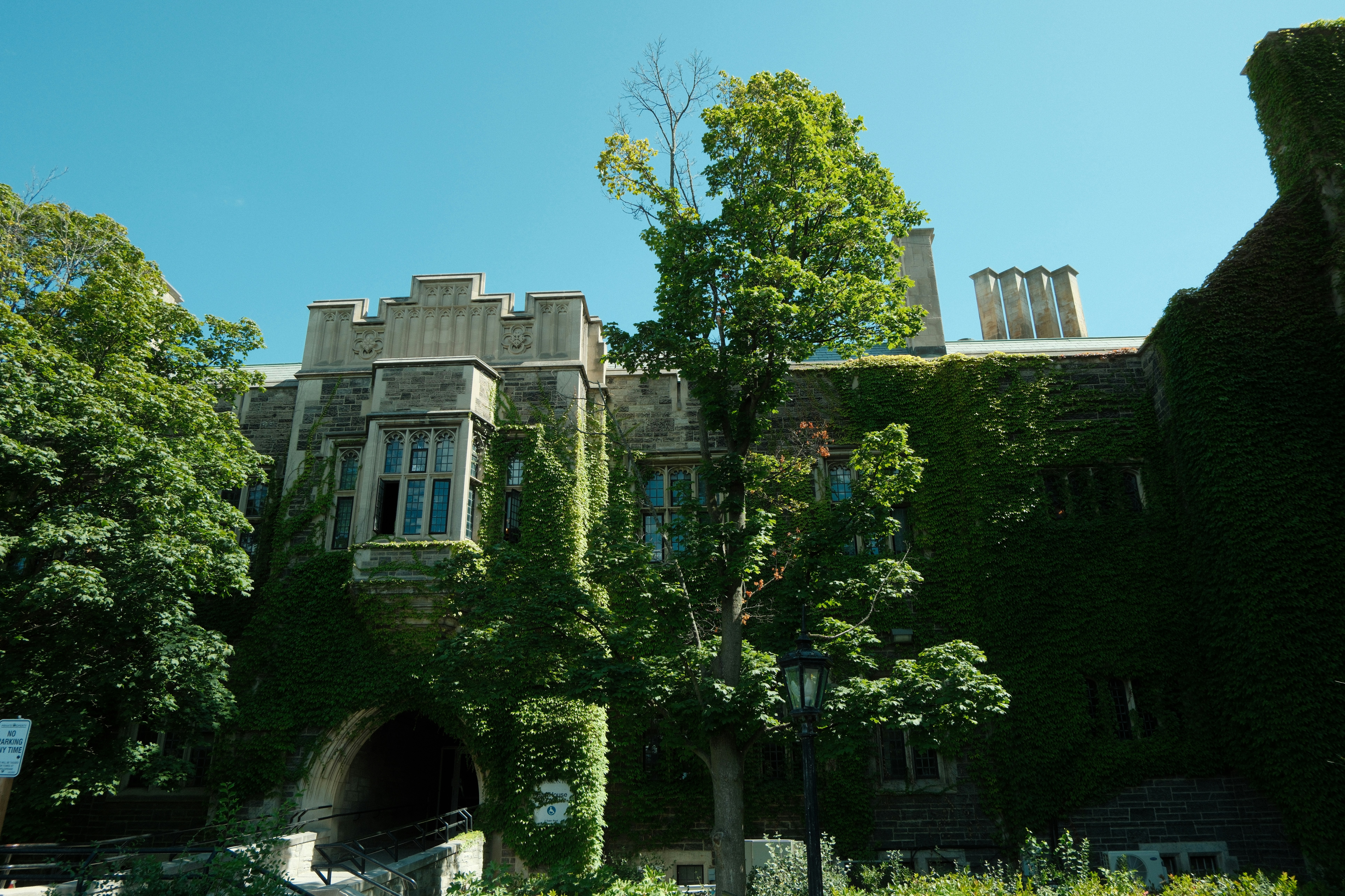 Ivy-covered Gothic stone building at the University of Toronto, a Canadian designated learning institution