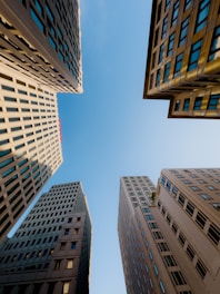 Tall office buildings against a clear blue sky.