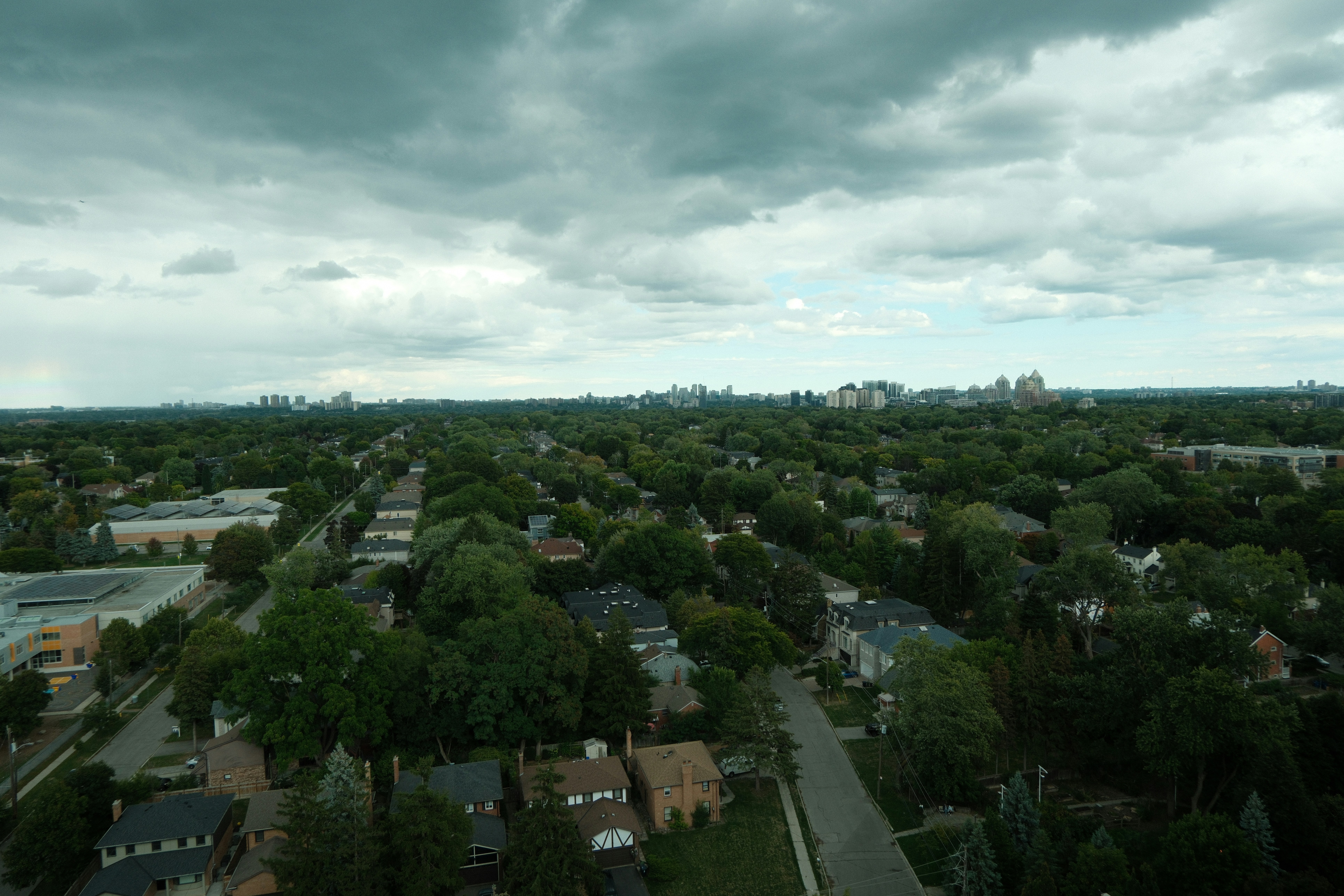 storm clouds over a residential neighborhood - roofing Berryville AR