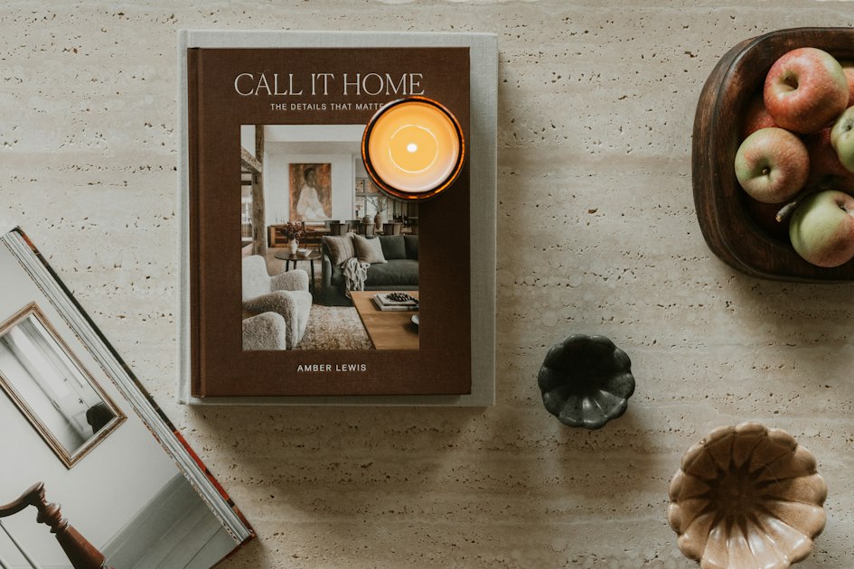 A book, candle, and apples on a table, a quiet still life
