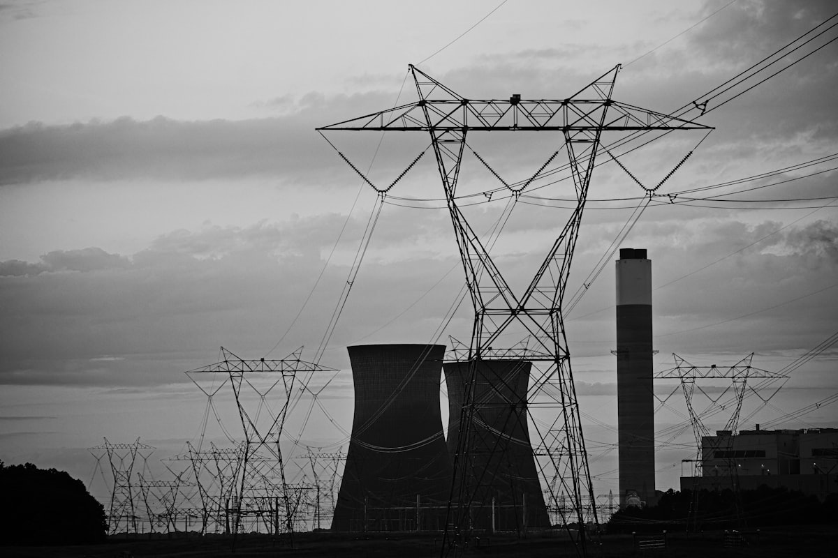 Power lines and cooling towers against a cloudy sky at a power plant in Georgia