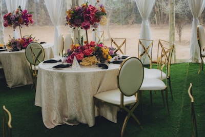 Elegant tables set with colorful floral arrangements for an event.