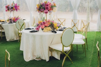 Elegant tables set with floral centerpieces for an event.