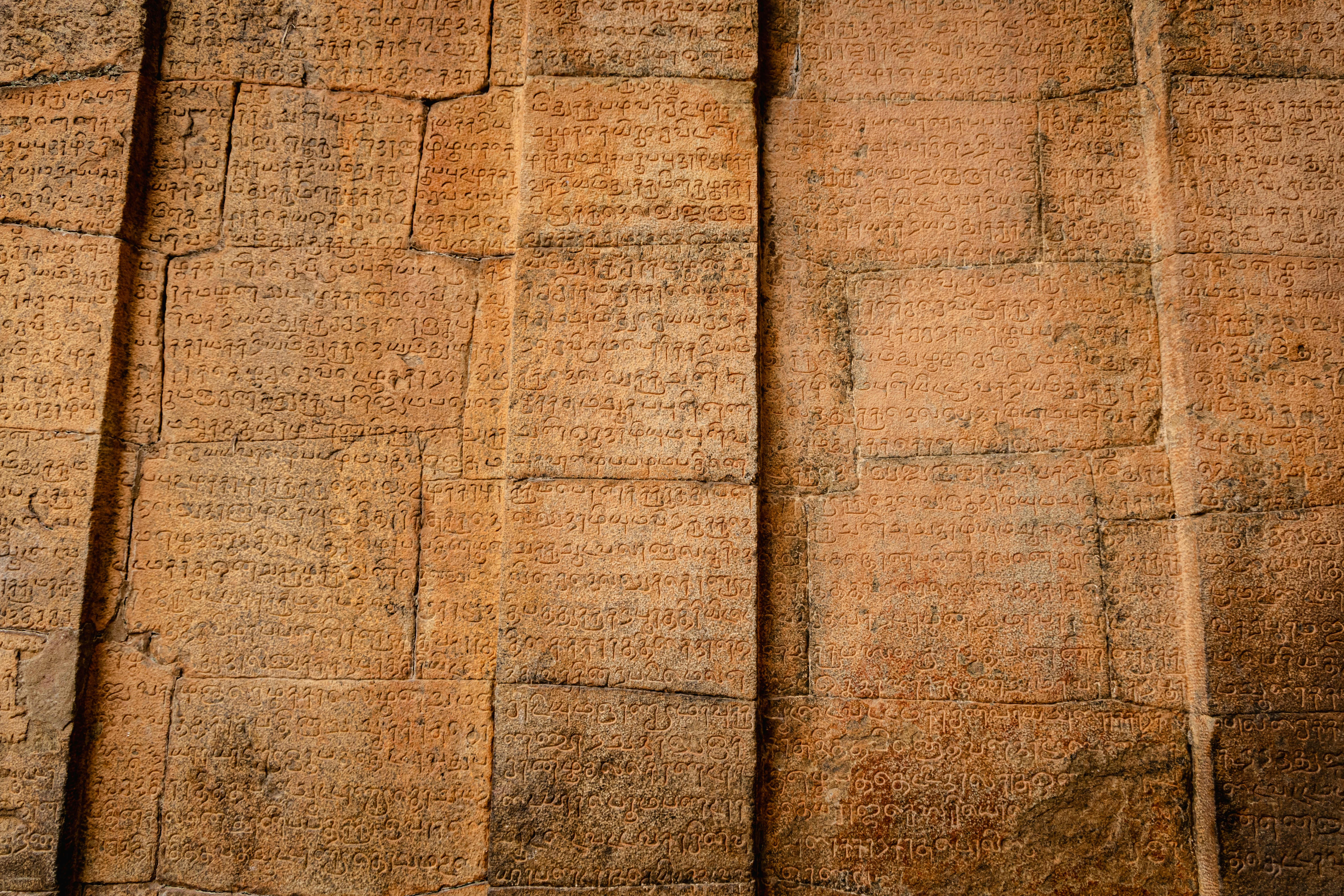 Ancient stone wall with carved inscriptions