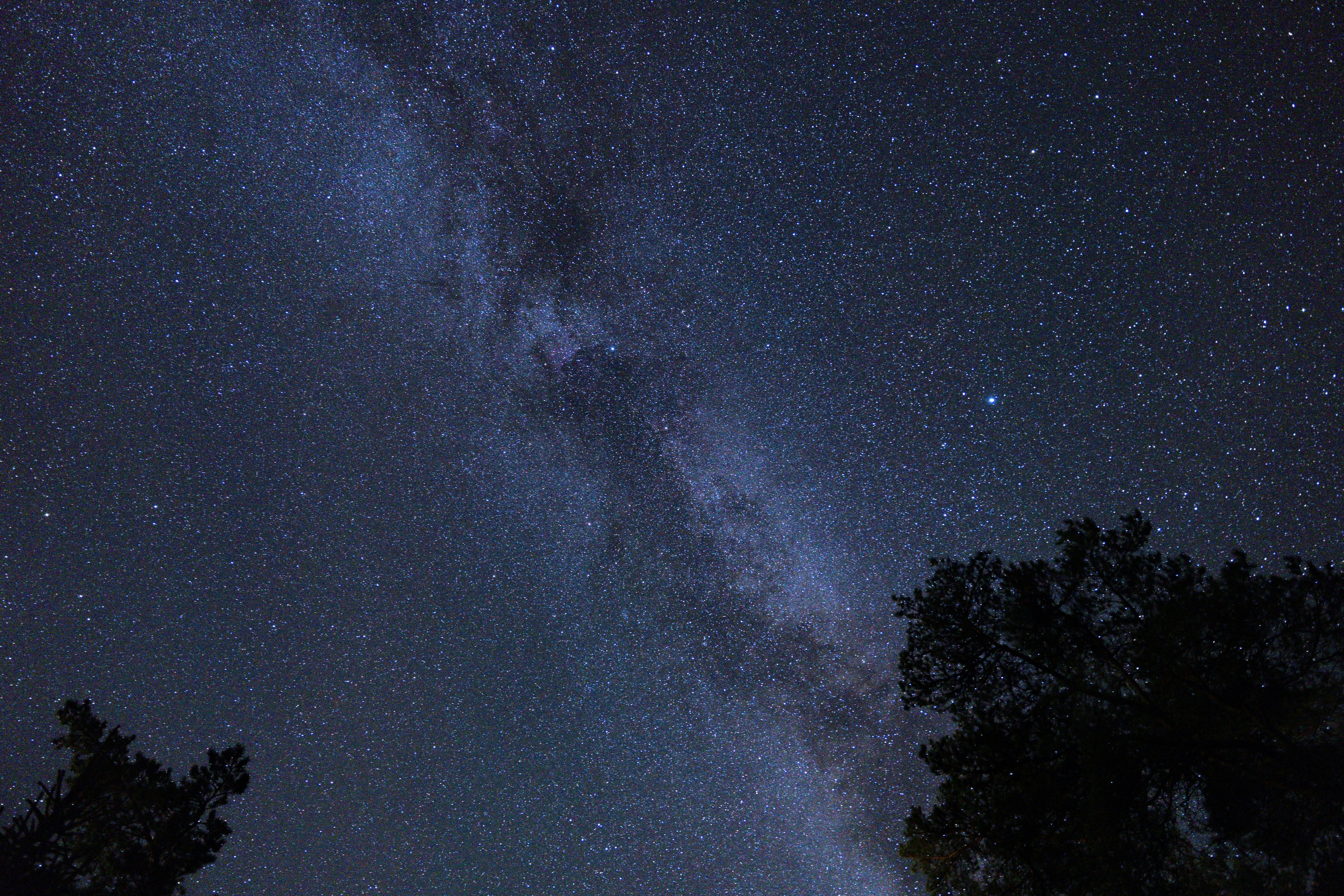 The milky way galaxy stretches across a dark night sky
