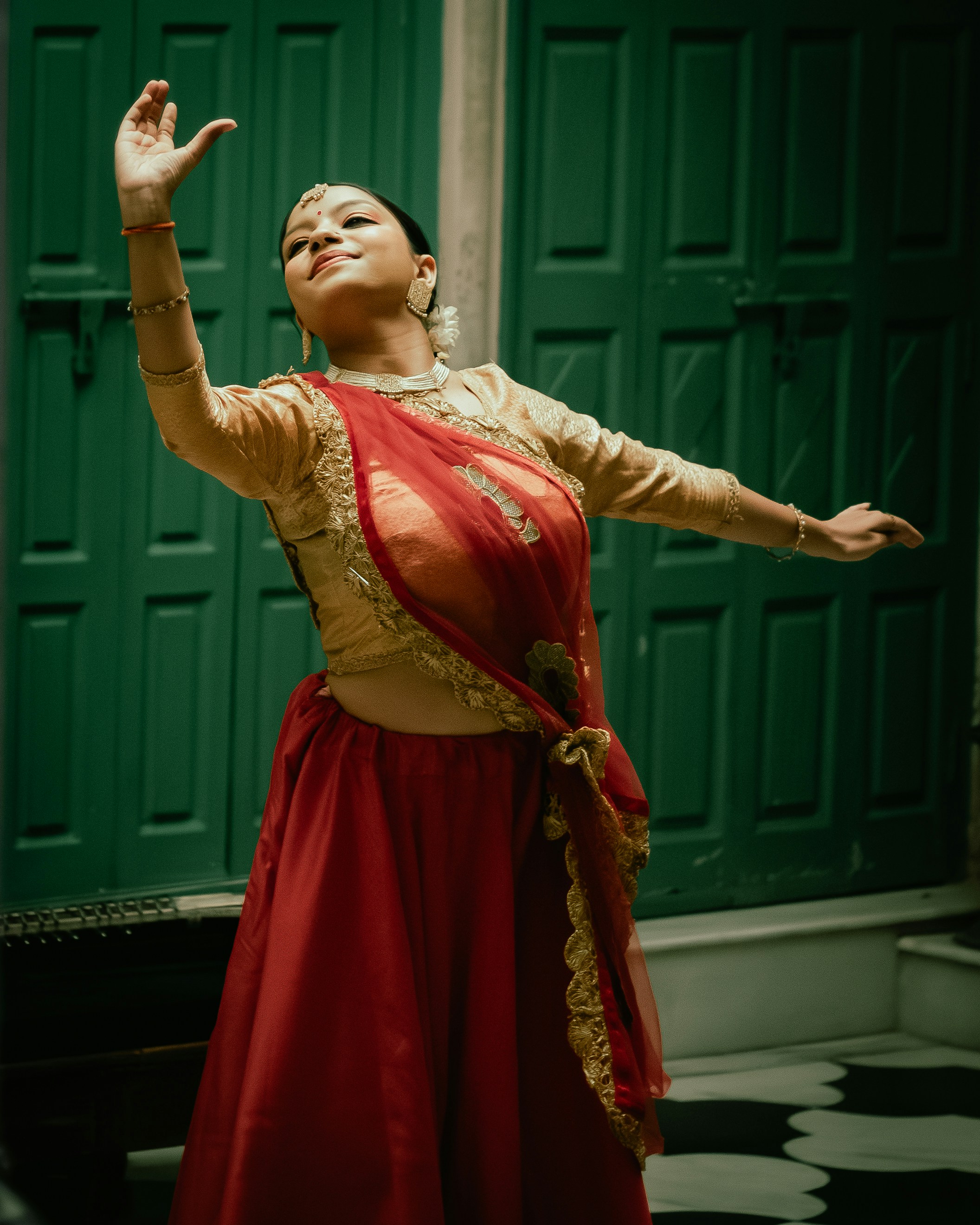A woman in traditional indian attire dances gracefully.