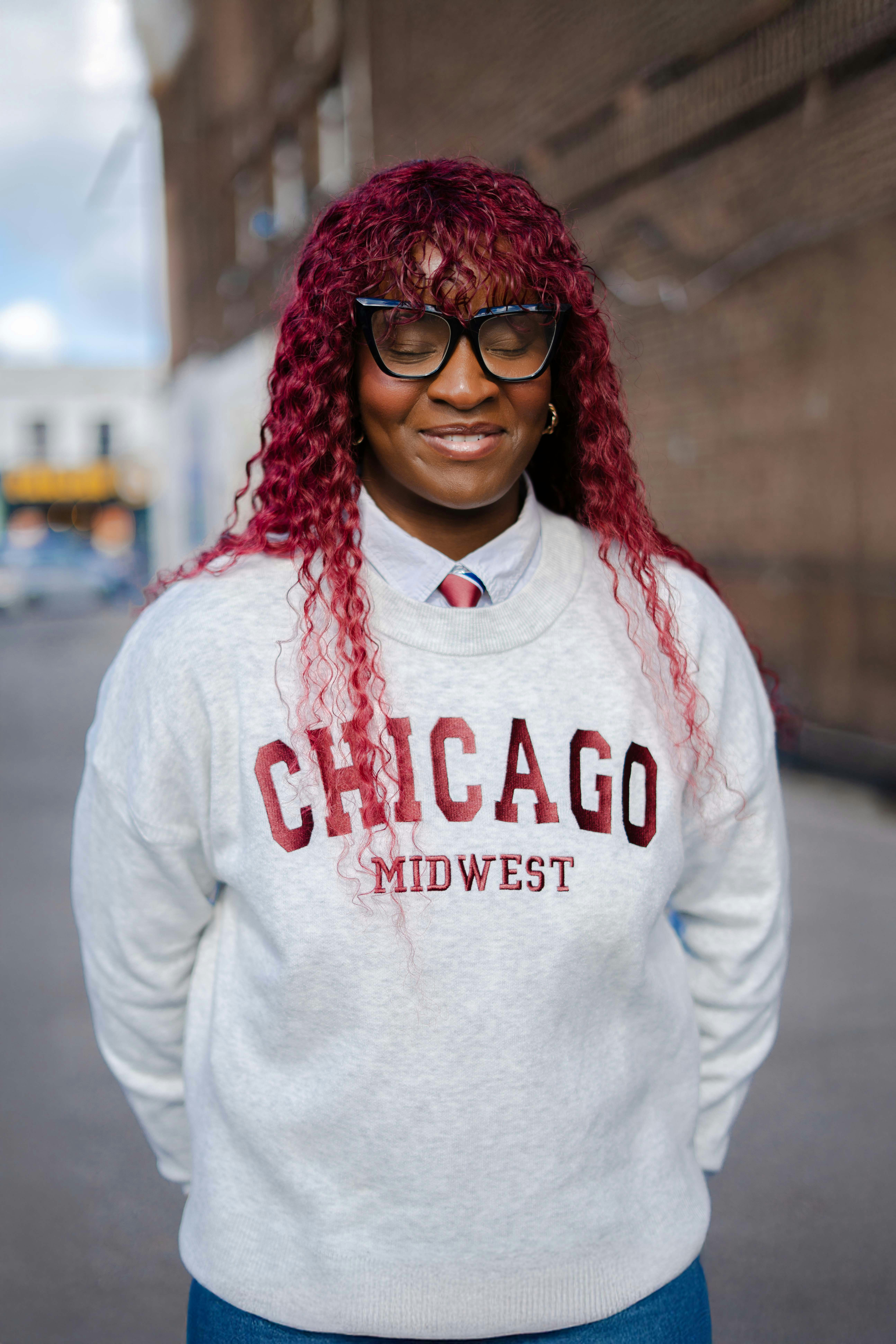 Woman with curly red hair wearing chicago sweatshirt