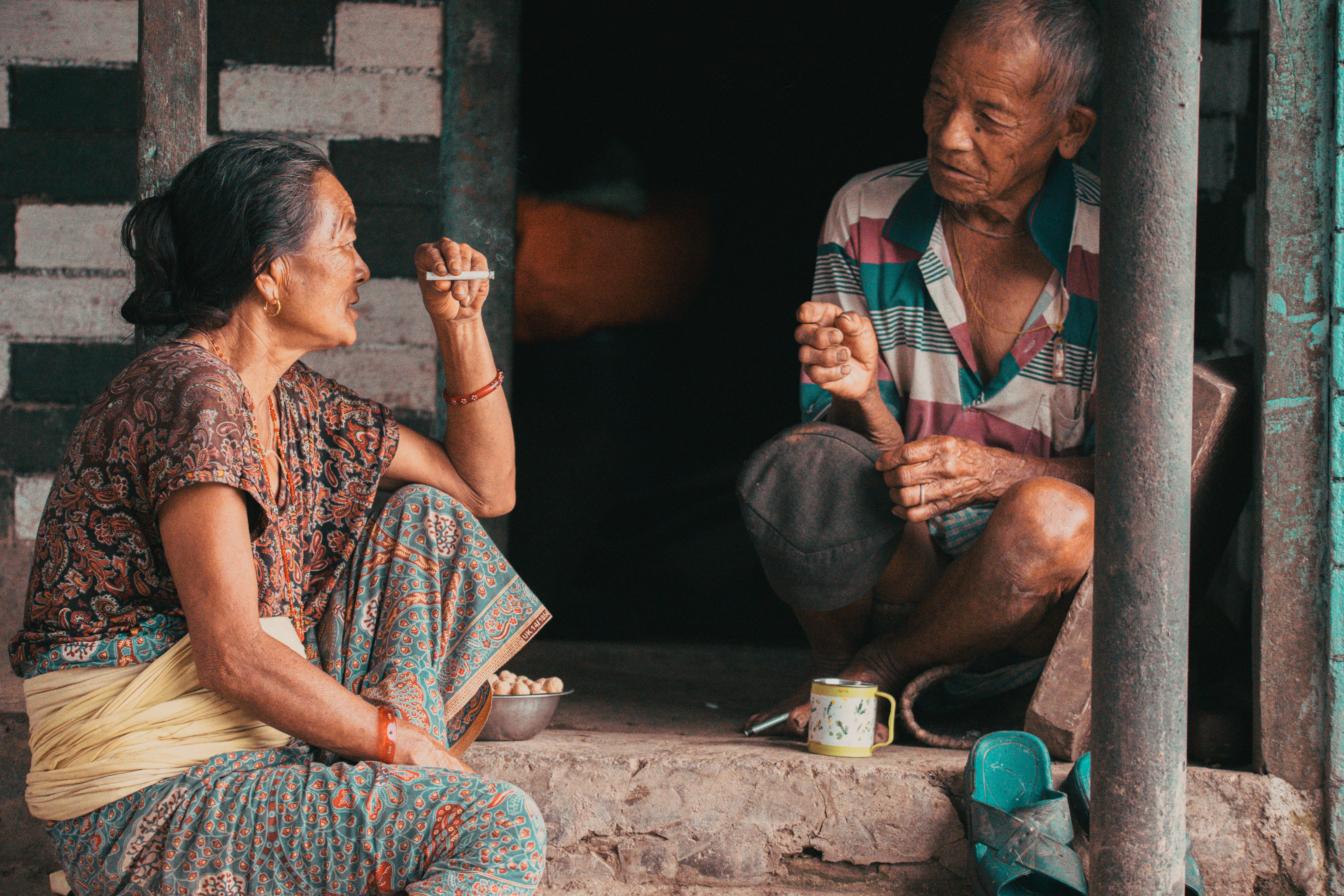 Elderly couple having a conversation while sitting on steps