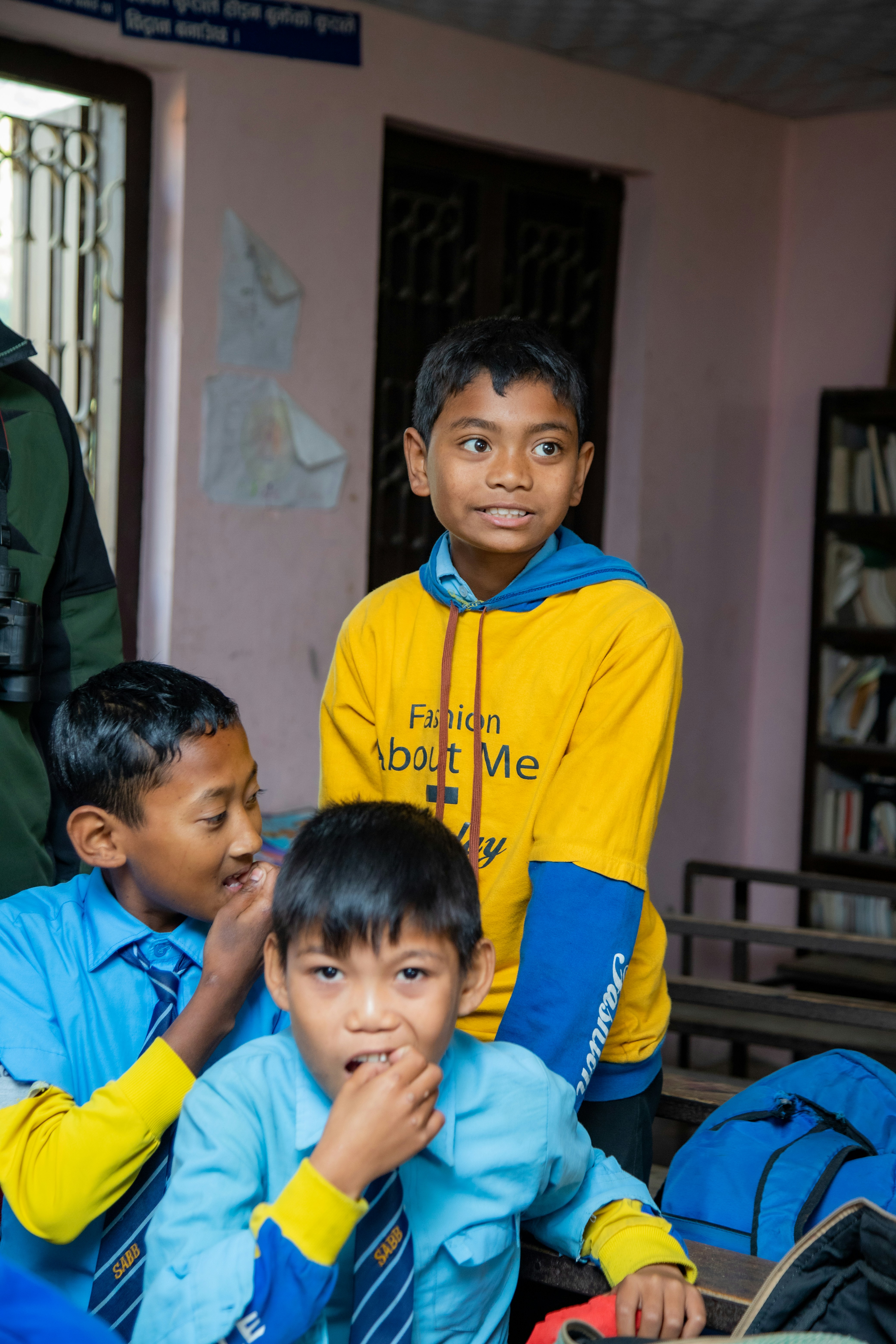 Three young boys in a classroom setting.