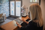Woman using a tablet at a reception desk.