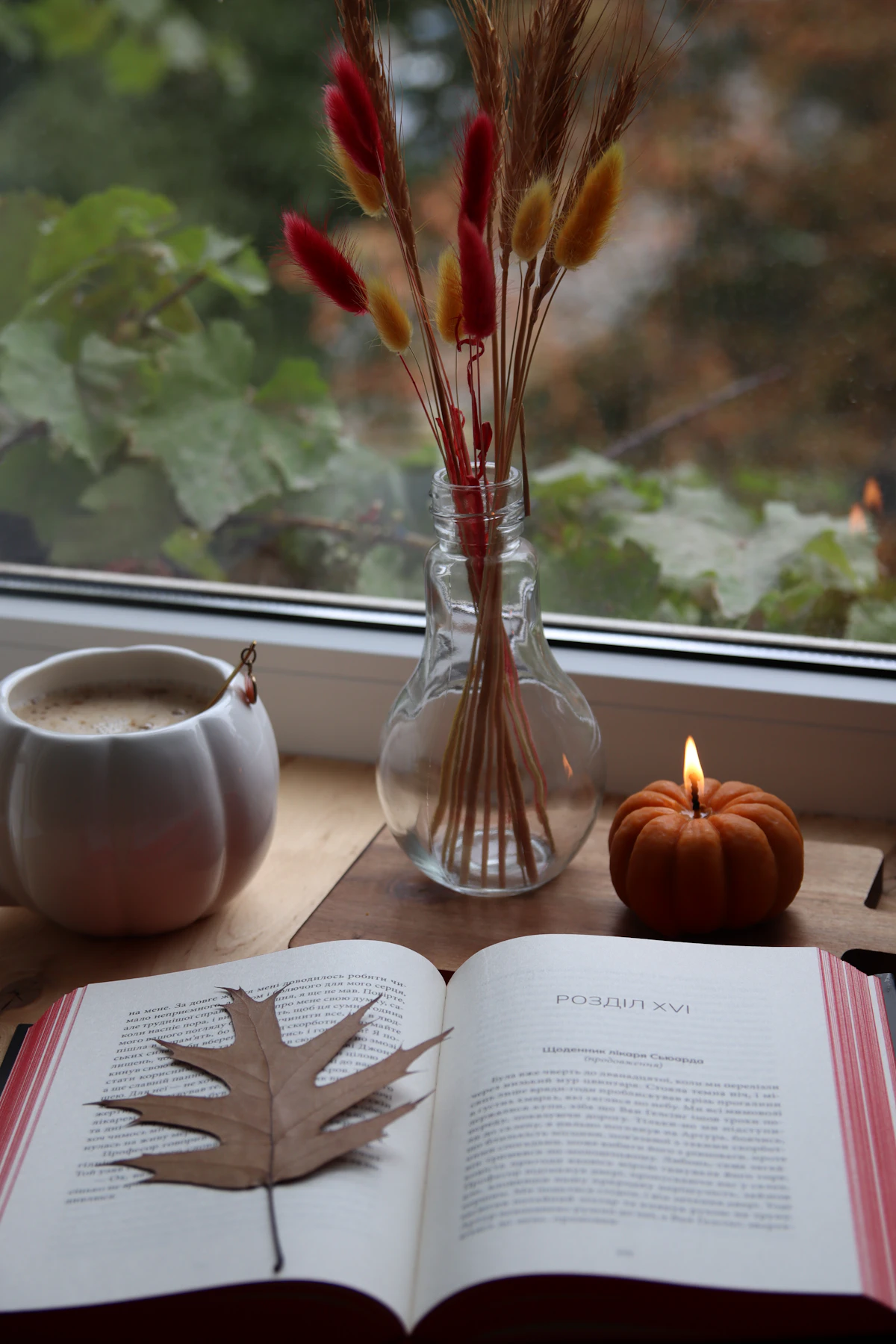 Autumn still life with a book, a coffee cup and a candle