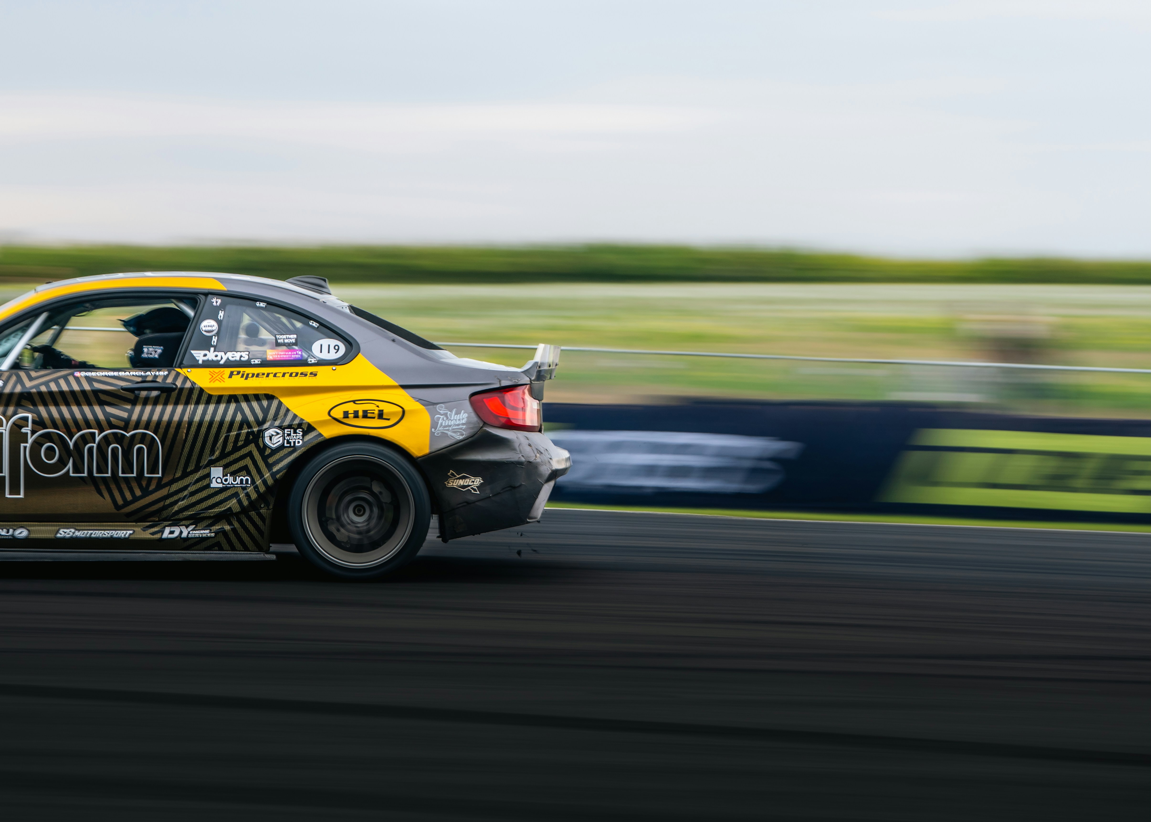 Race car drifting on a track with motion blur