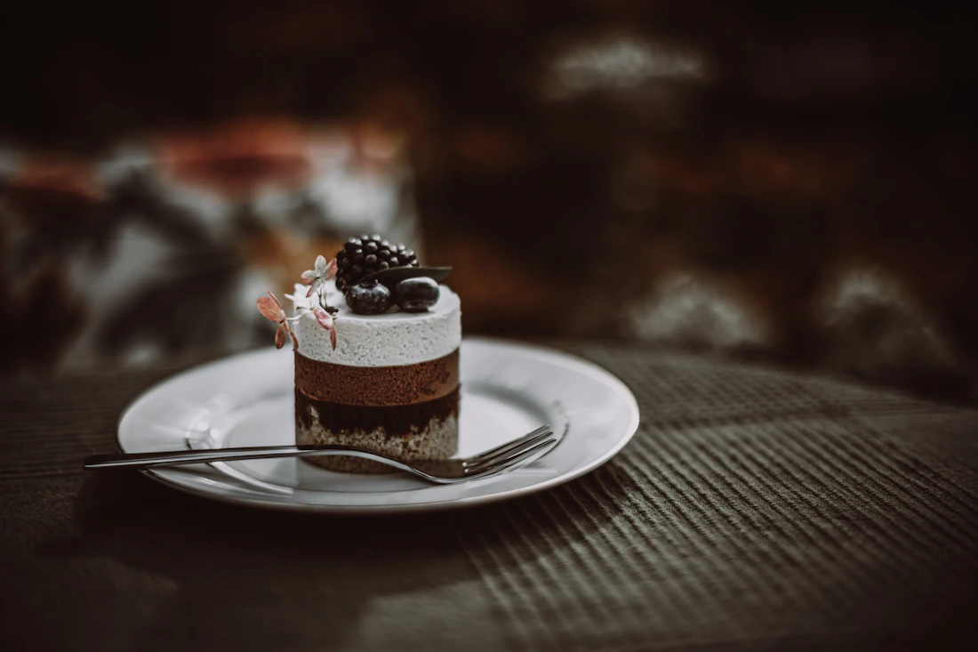 Small layered chocolate cake topped with berries
