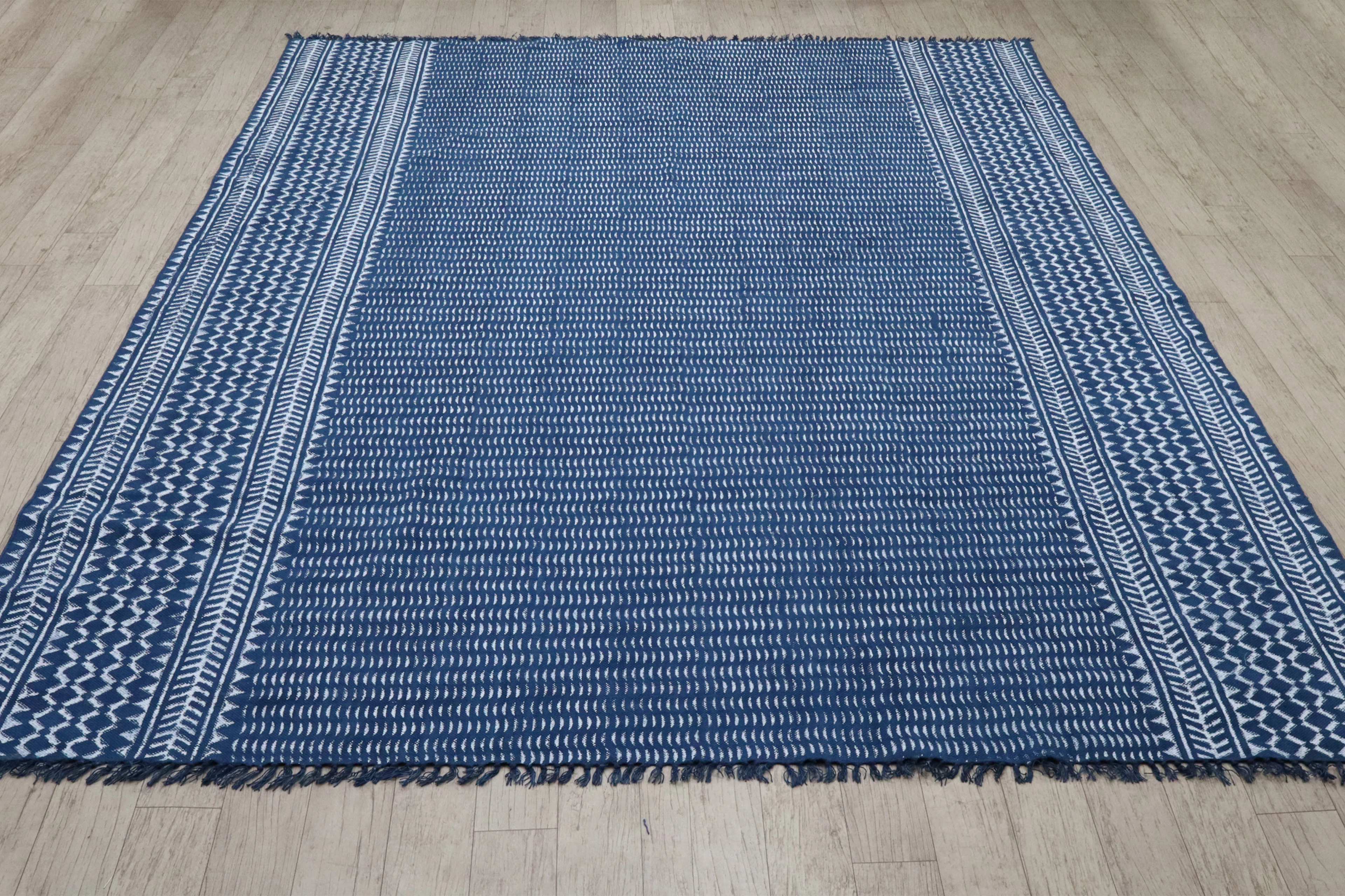 Indigo flatweave rug on a timber floor