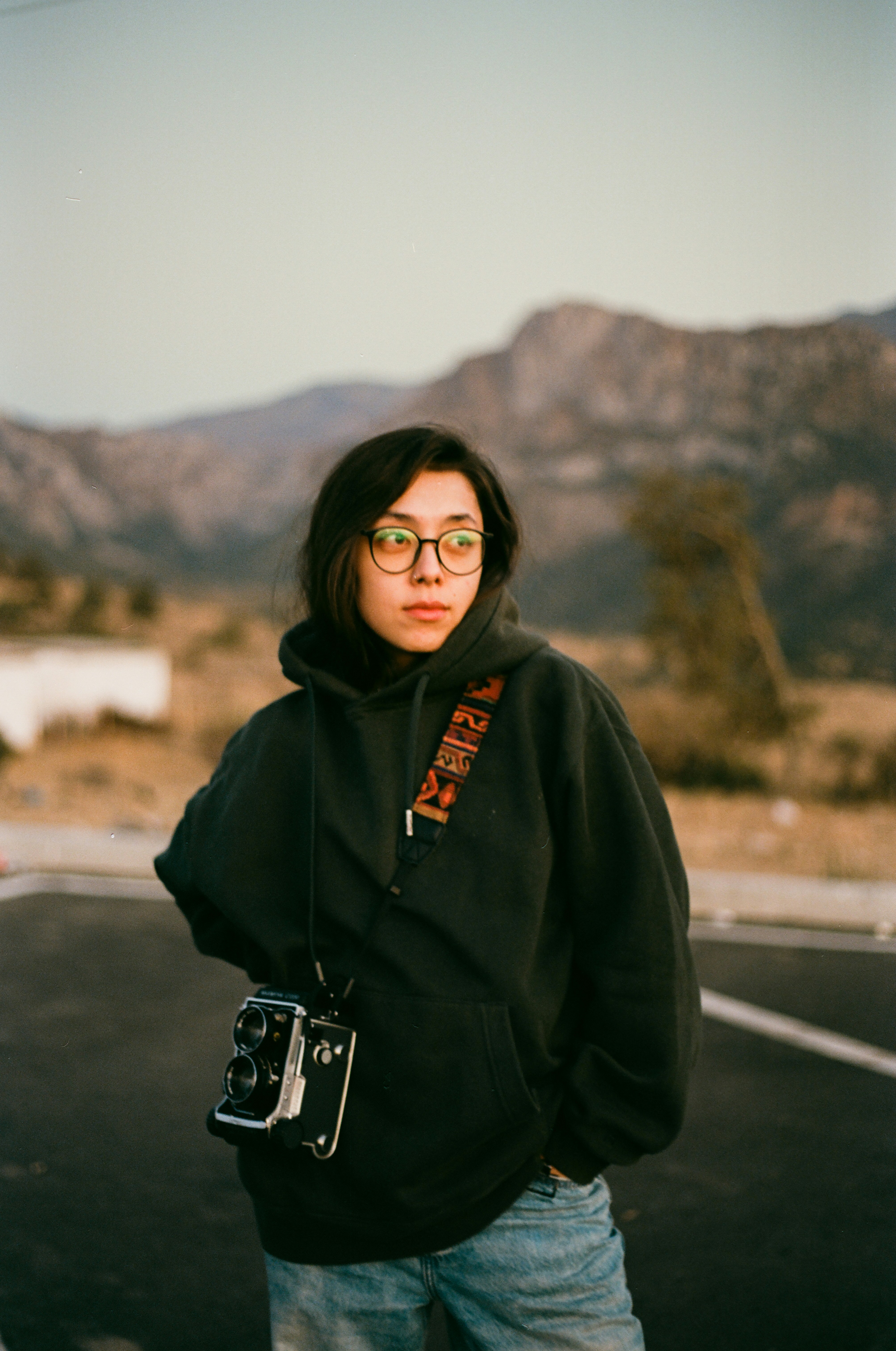 Young woman with vintage camera and mountains