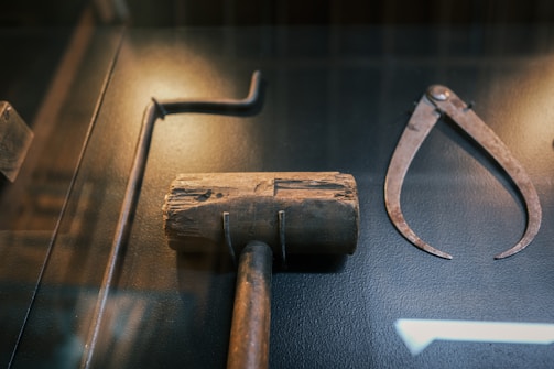 Antique tools including a mallet and calipers
